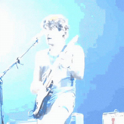 Man Playing Guitar In Front Of Microphone GIF