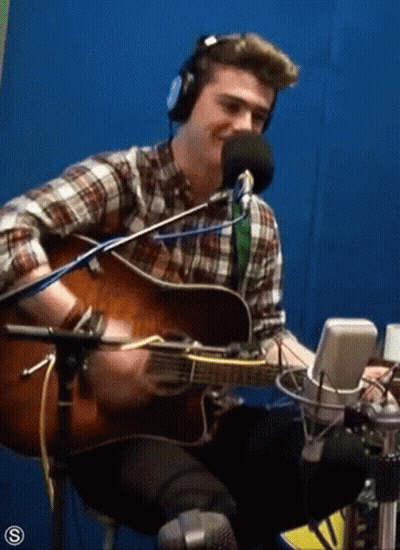 Man Playing Guitar In Front Of Microphone GIF
