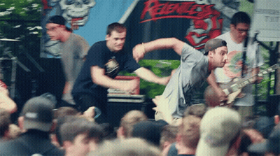 Man Playing Guitar In Front Of Rebels Sign GIF