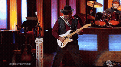 Man Playing Guitar In Front Of WSM Sign GIF