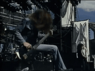 Man Playing Guitar In Front Of X Sign GIF
