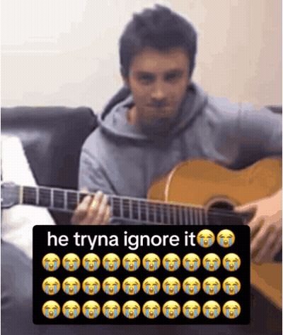 Man Playing Guitar Next To Keyboard Saying He Tryna Ignore It GIF