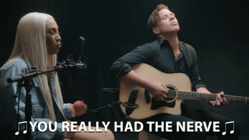 Man Playing Guitar Next To Woman Singing Nerve GIF