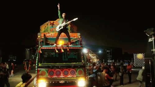 Man Playing Guitar On Cit Truck GIF