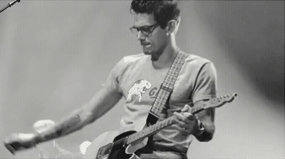 Man Playing Guitar On Stage Black And White GIF