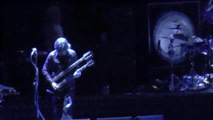 Man Playing Guitar On Stage With Drum Set GIF