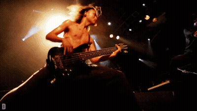 Man Playing Guitar On Stage With Letter D GIF