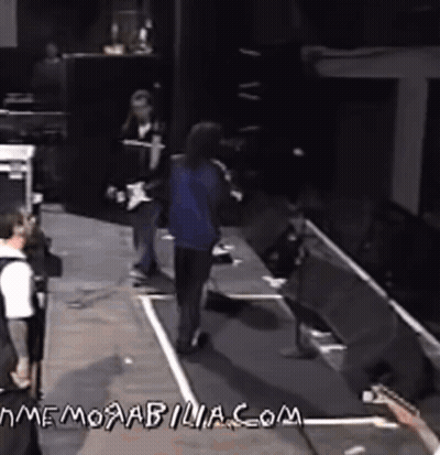 Man Playing Guitar On Stage With Memorabilia.com GIF
