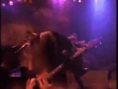 Man Playing Guitar On Stage With Purple Lights GIF