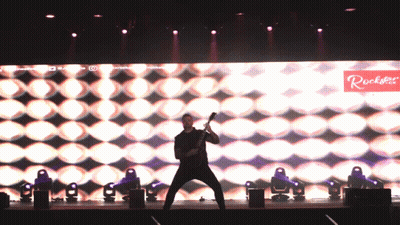 Man Playing Guitar On Stage With Rockstar Sign GIF