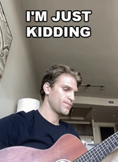 Man Playing Guitar Saying I'm Just Kidding GIF