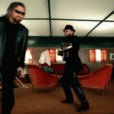 Man Playing Guitar While Another Dances GIF