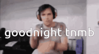 Man Playing Guitar While Another Lays On Stage GIF