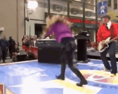 Man Playing Guitar While Woman Dances GIF