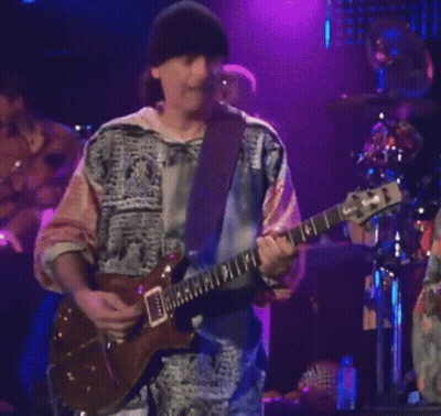 Man Playing Guitar With Band Saying Santana GIF