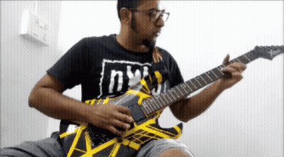 Man Playing Guitar With Shirt Saying NY GIF
