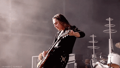 Man Playing Guitar With X On Belt GIF