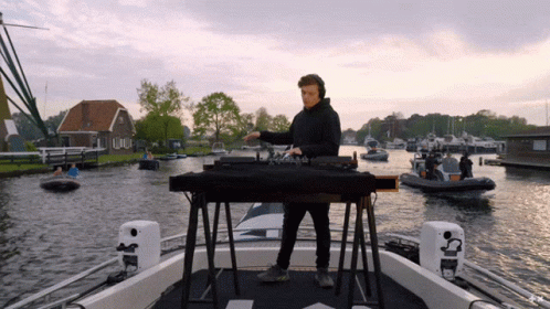 Man Playing Music On Boat With Boats GIF
