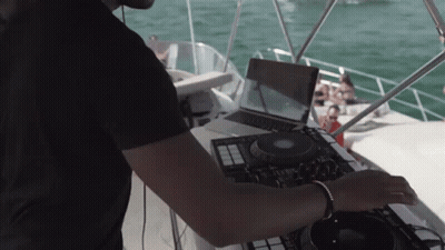 Man Playing Music On Boat With Laptop GIF
