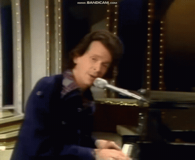 Man Playing Piano At Microphone GIF
