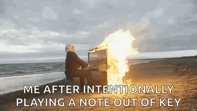Man Playing Piano On Beach With Fire GIF