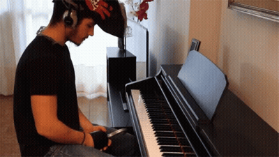 Man Playing Piano With Headphones GIF