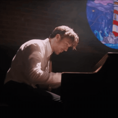 Man Playing Piano With Stained Glass Window GIF