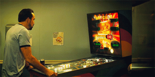 Man Playing Pinball Machine Saying Arcade GIF