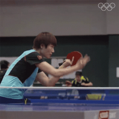 Man Playing Ping Pong With Olympic Rings GIF