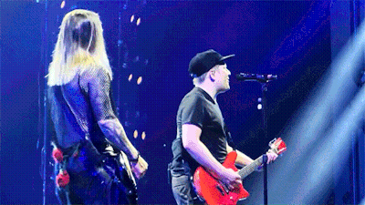 Man Playing Red Guitar On Stage With Singer GIF