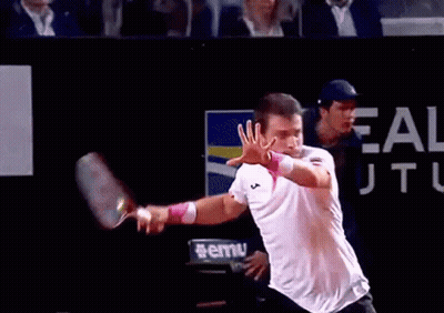 Man Playing Tennis In Front Of Ale Sign GIF