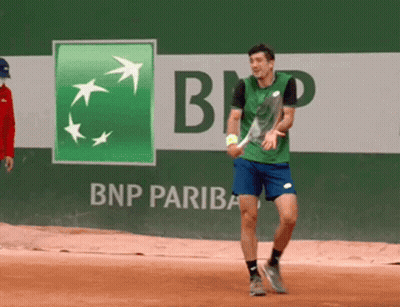 Man Playing Tennis In Front Of BNP Pariba Ad GIF