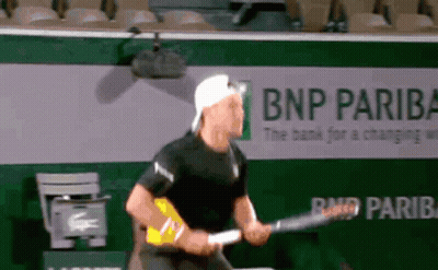 Man Playing Tennis In Front Of BNP Pariba Ad GIF