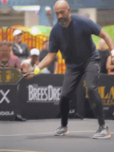 Man Playing Tennis In Front Of Brees Dre Ad GIF