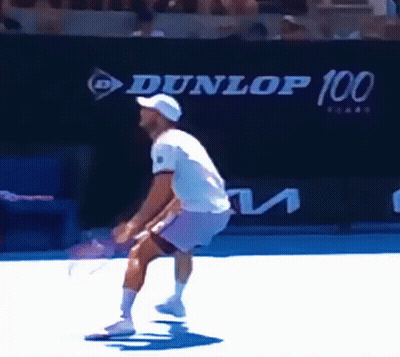 Man Playing Tennis In Front Of Dunlop 100 Sign GIF
