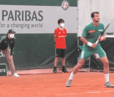 Man Playing Tennis In Front Of Paribas Banner GIF