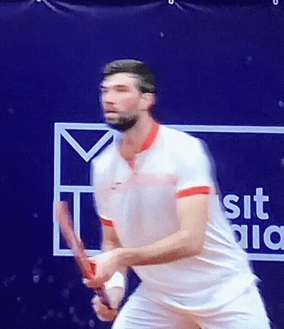 Man Playing Tennis Next To Sit Sign GIF