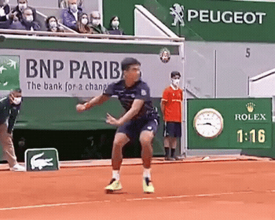 Man Playing Tennis On Clay Court In Front Of BNP Pariba Ad GIF