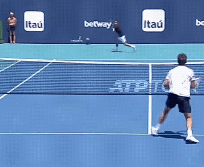 Man Playing Tennis With Itau Ads Behind GIF