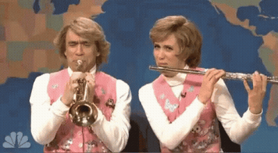 Man Playing Trumpet And Woman Playing Flute In Front Of World Map GIF
