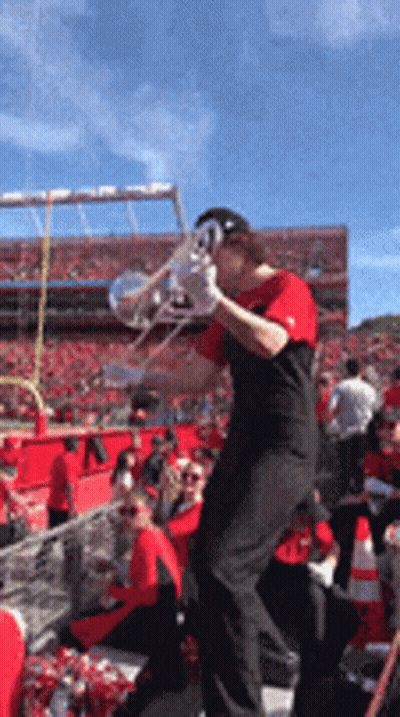 Man Playing Trumpet At Football Game GIF