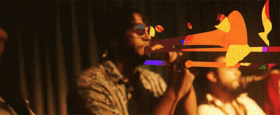 Man Playing Trumpet In Dark Room, Another Watches GIF