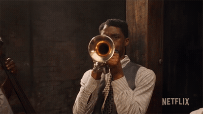 Man Playing Trumpet With Netflix Logo GIF