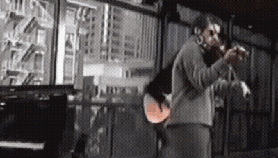 Man Playing Violin In Front Of Piano And Window GIF