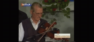 Man Playing Violin In Front Of Sign Kuogn GIF