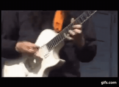 Man Playing White Electric Guitar With Orange Tie GIF