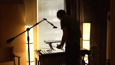 Man Playing Xylophone In Dark Room GIF