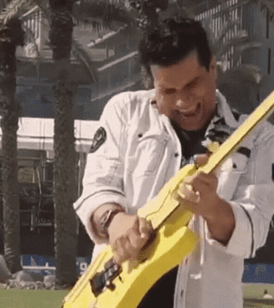 Man Playing Yellow Guitar Outdoors GIF