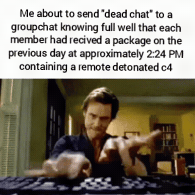 Man Pointing at Camera at Desk With Keyboard
