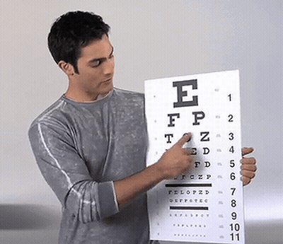 Man Pointing At Eye Chart With Letter E GIF